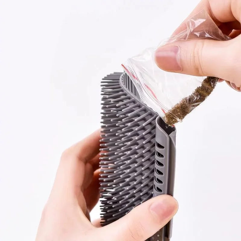 Person using a pet grooming brush with a clear plastic bag attached to collect hair.
